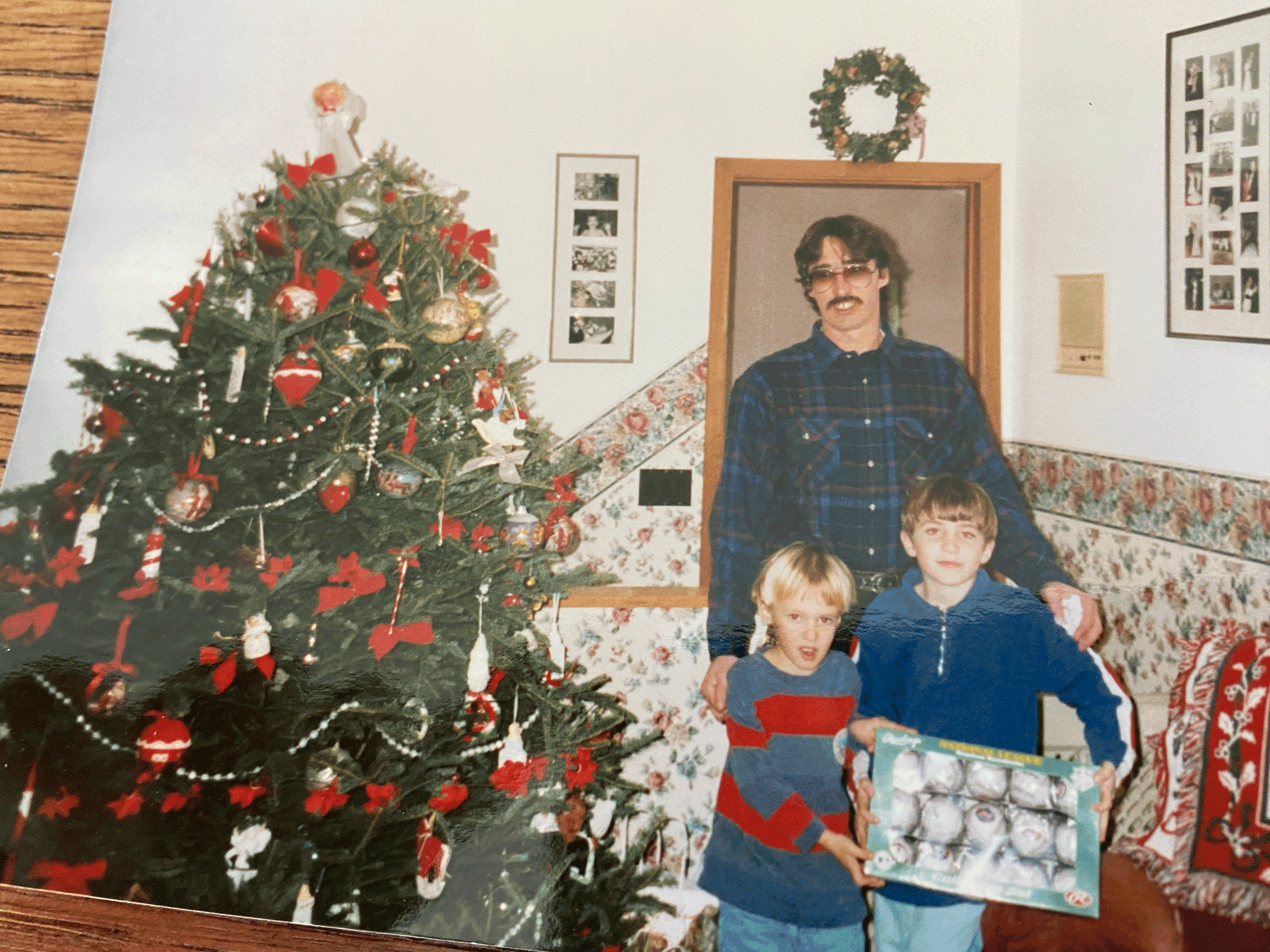 dad and two boys by christmas tree in the 90s
